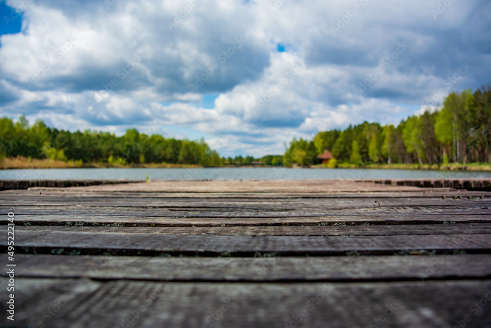 Blurred background with wooden pier on the shore of a large lake in the forest. Wonderful spring landscape. A cozy place for rest, meditation and fishing
Blurred background with wooden pier on the shore of a large lake in the forest. Wonderful spring landscape. A cozy place for rest, meditation and fishing