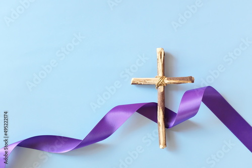 Obraz na płótnie Top view flat lay of wooden cross crucifix with violet purple ribbon cloth with copy space. Holy week, lent season, Catholicism and Christianity concept. w salonie
