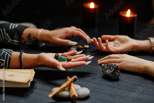 Bild auf Leinwand Close up of gypsy holding crystals and reading clients destiny in dark fortune t