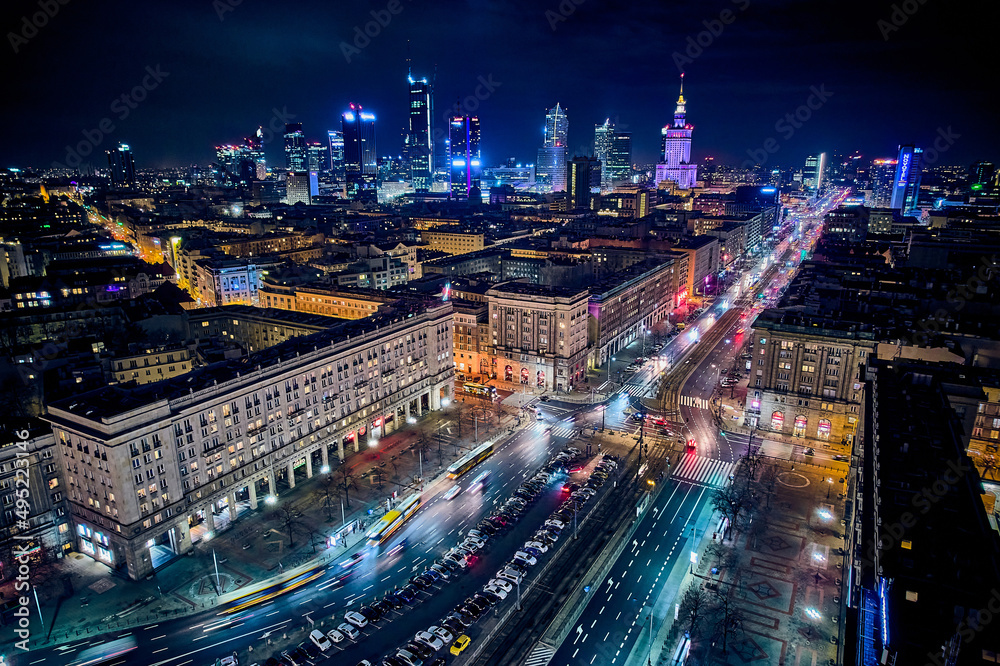 Fototapeta premium Constitution Square (PL: Plac Konstytucji) - a view of the center of night Warsaw with skyscrapers in the background - the lights of the big city by night, Poland, EU
