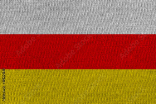 Patriotic textile background in colors of national flag. South Ossetia