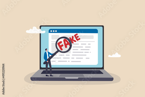 Fake news or false information spreading on website and social media, screening or verify truth before sharing or believe concept, man with magnifying glass verify fake news on website on computer. photo