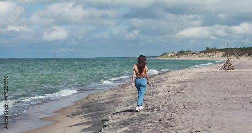Curonian spit, beautiful vibrant view of Kurshskaya Kosa National Park, Curonian Lagoon and the Baltic Sea, Kaliningrad Oblast, Russia and Klaipeda County, Lithuania, summer day, with a female tourist photo