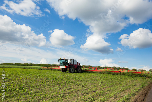 Agricultural tractor spraying the field