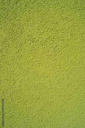 Pattern of green rough sandy wall plaster as a background, closeup, details