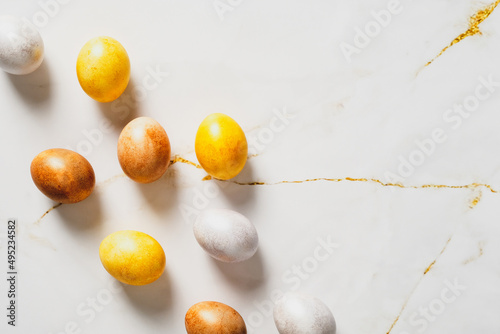 Elegant Easter flatlay composition. Luxury bronze Easter eggs on marble table. Flat lay, top view.