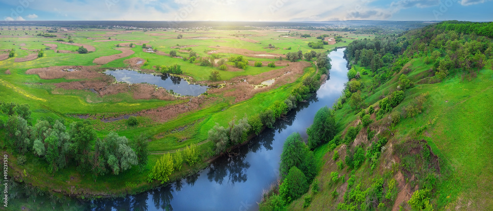 Panorama of a river flowing in a green valley Panorama of a river flowing in a green valley