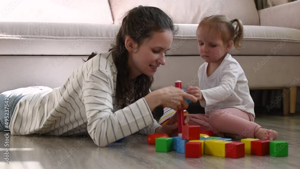 Mother and little girl is playing with toys. Mother and little girl is playing with toys.