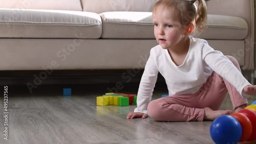 Little girl is playing with toys.