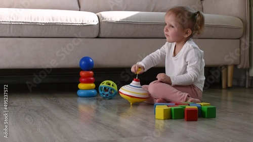 Little girl is playing with pinwheel
