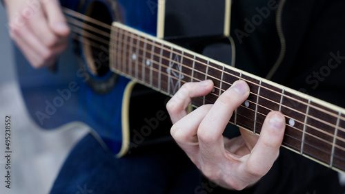 man playing guitar chord in C major