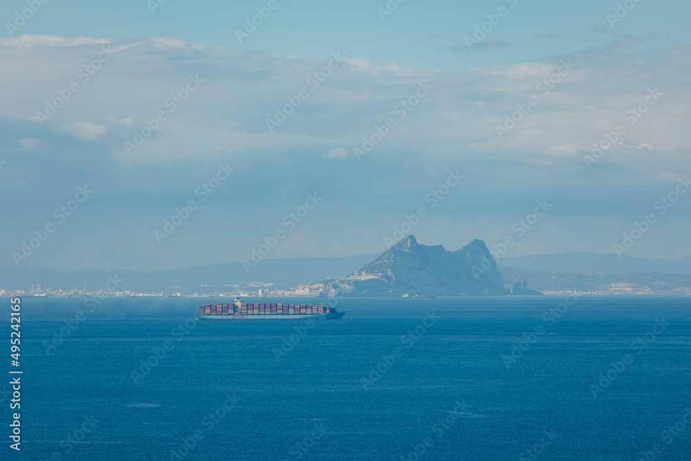 View from Ceuta of a cargo ship crossing the Strait of Gibraltar with the rock in the background. View from Ceuta of a cargo ship crossing the Strait of Gibraltar with the rock in the background.