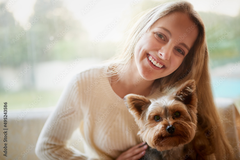 Spending the weekend with my best friend. Portrait of an attractive young woman and her puppy sitting on the sofa at home. Spending the weekend with my best friend. Portrait of an attractive young woman and her puppy sitting on the sofa at home.