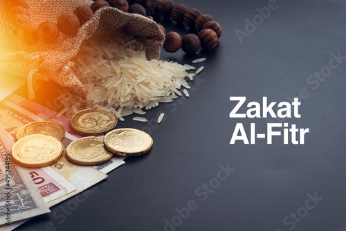 ZAKAT words with Rice, Banknotes, Coins and Rosary Beads or Tasbih on Black Background. Zakat and Islamic Concept