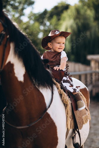 Little cowboy sitting on a horse