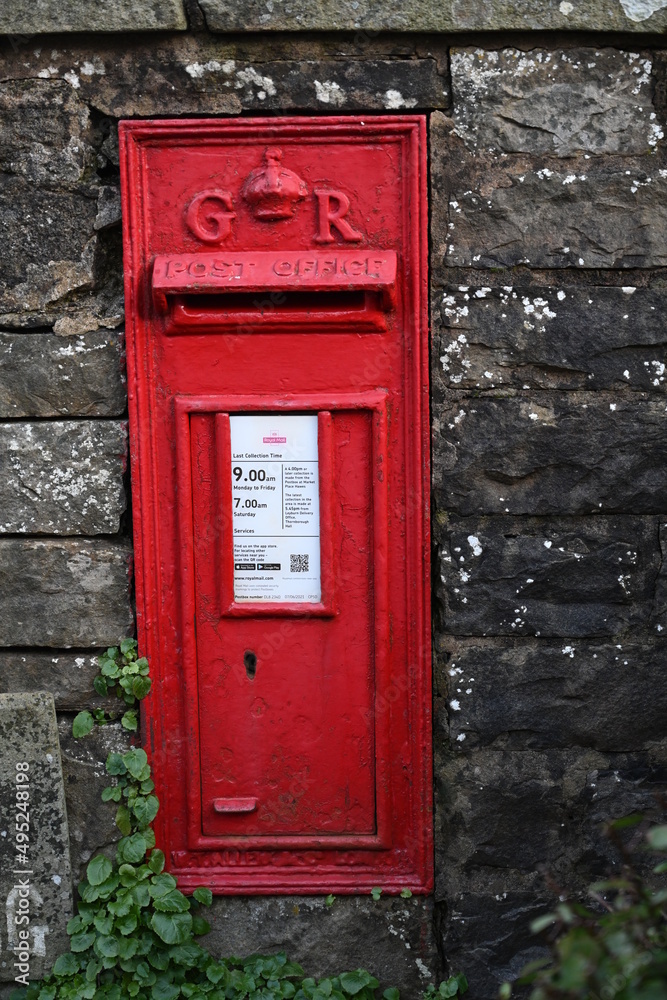British postal service, red post box in the British countryside British postal service, red post box in the British countryside