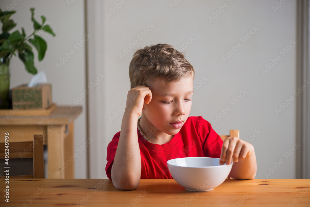 Cute boy eats granola for breakfast. Lifestyle portrait. Cute boy eats granola for breakfast. Lifestyle portrait.
