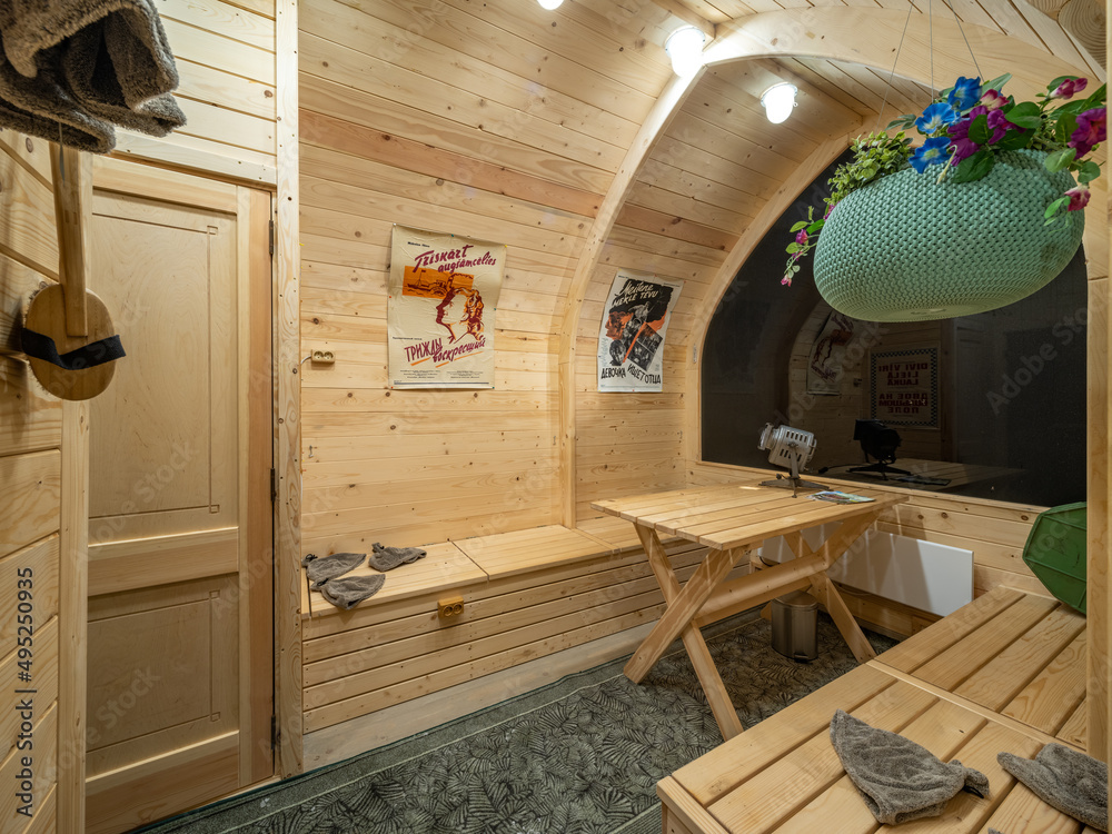Wooden interior of modern bathhouse. Table and benches.