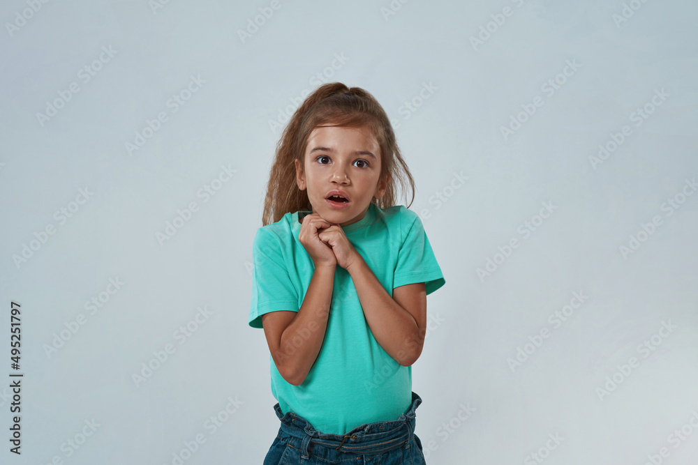 Scared girl with open mouth and clasped hands Scared girl with open mouth and clasped hands