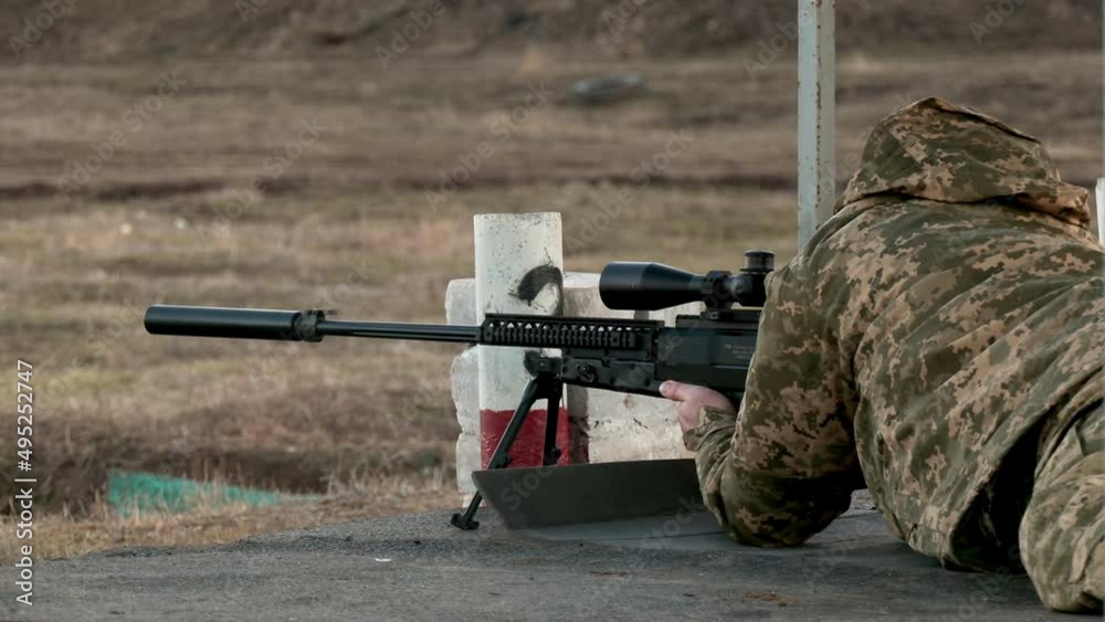 A military soldier shoots from a sniper rifle. A professional sniper prepares modern weapons for shooting. Focused man loading a firearm in position. War in Ukraine
A military soldier shoots from a sniper rifle. A professional sniper prepares modern weapons for shooting. Focused man loading a firearm in position. War in Ukraine