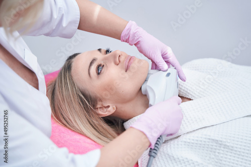Female patient undergoing non-surgical skin tightening procedure