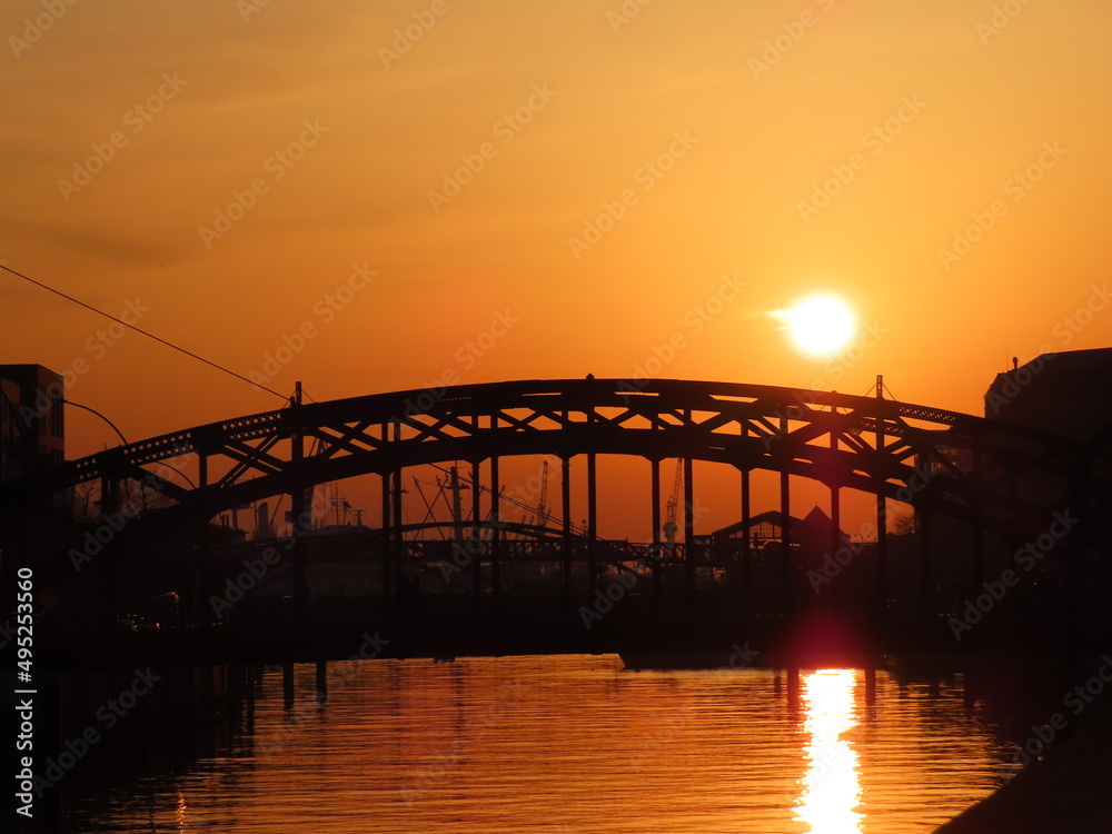 sunset over a river in a city