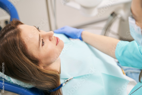 Woman lying in dental chair in stomatology clinic