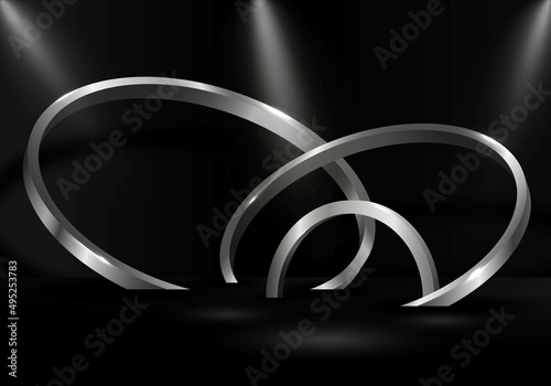 Abstract silver metallic ring display 3D artwork with spotlight background.