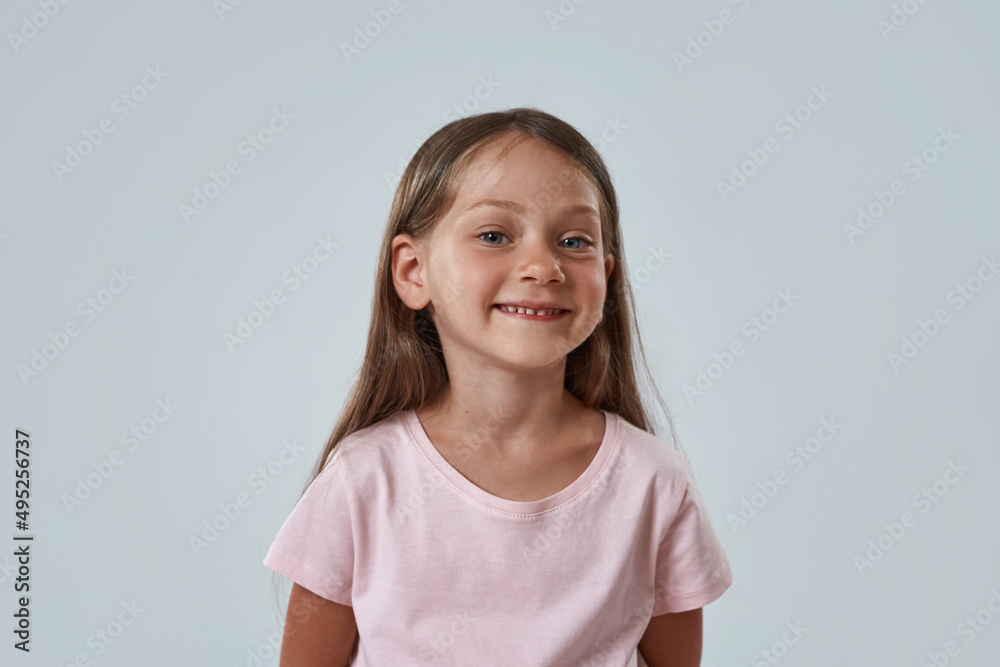 Cute caucasian smiling little girl look at camera