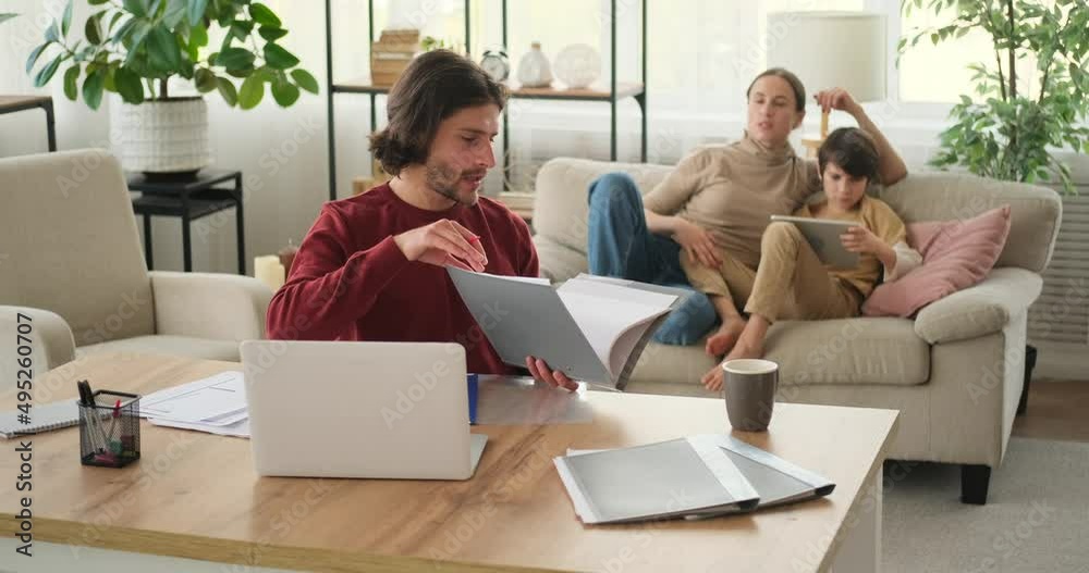 Woman discussing with husband working from home while son is using digital tablet Woman discussing with husband working from home while son is using digital tablet