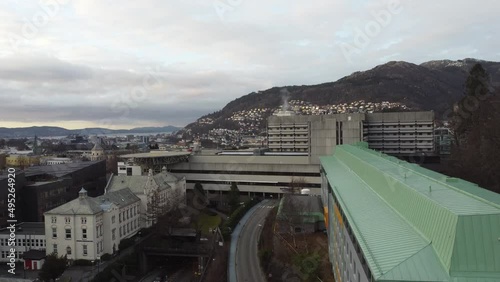 Haukeland university hospital in city of Bergen Norway - Upward moving aerial with tilt down over hospital buildings photo