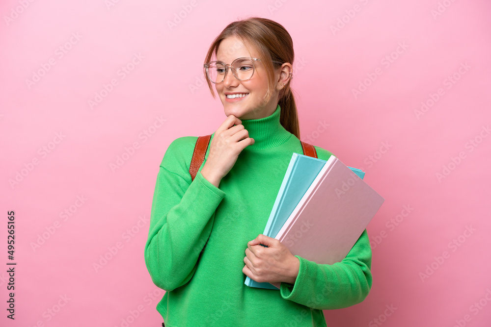 Young caucasian student woman isolated on pink background looking to the side and smiling Young caucasian student woman isolated on pink background looking to the side and smiling