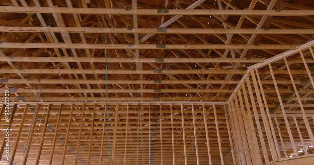 Wooden roof trusses framework on stick built home the under construction framing an interior view Wooden roof trusses framework on stick built home the under construction framing an interior view