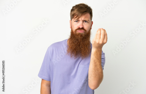 Young reddish caucasian man isolated on white background making Italian gesture