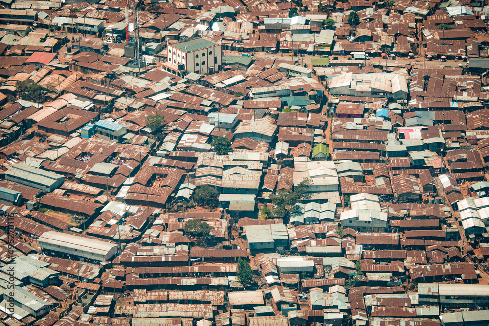 Aerial view of corrugated iron huts at the Nairobi downtown Kibera slum neighborhood, Nairobi, Kenya, East Africa, one of the largest slums in Africa Aerial view of corrugated iron huts at the Nairobi downtown Kibera slum neighborhood, Nairobi, Kenya, East Africa, one of the largest slums in Africa