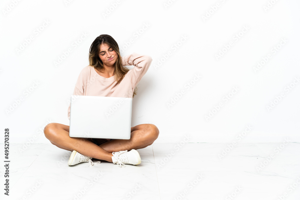 Young woman with a laptop sitting on the floor isolated on white background with neckache Young woman with a laptop sitting on the floor isolated on white background with neckache