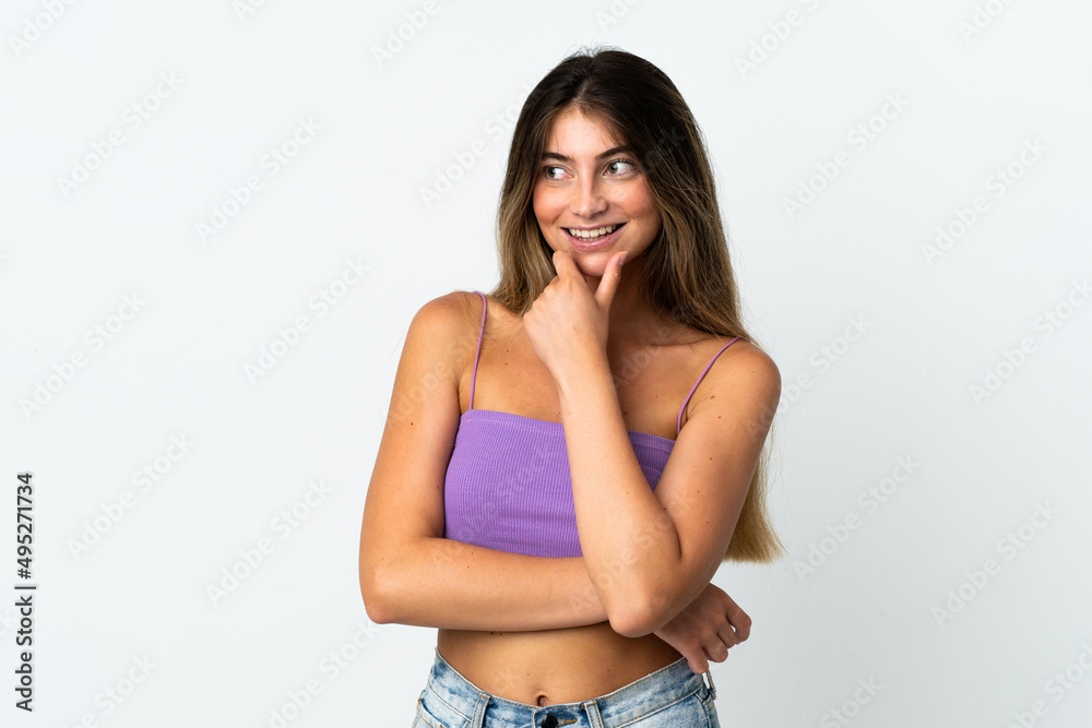 Fototapeta premium Young caucasian woman isolated on white background looking to the side and smiling