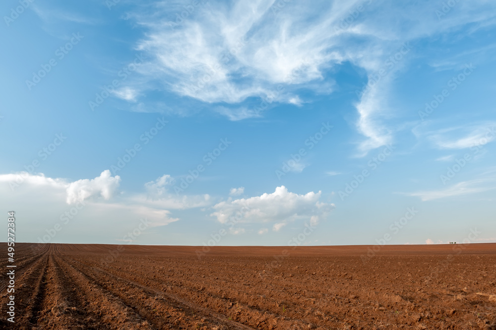 plowed field and blue sky in sunset plowed field and blue sky in sunset