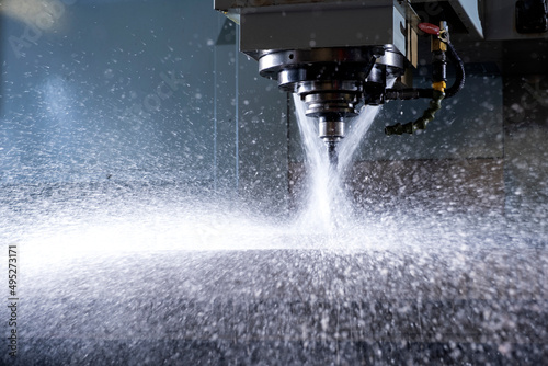 Close-up of industrial drill being sprayed with water.
