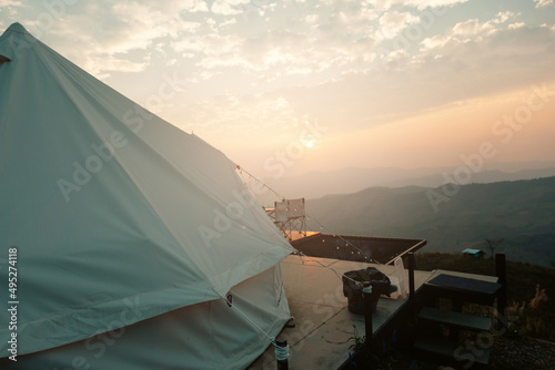 Camping on Mountain with colorful lights and shadows view during beautiful sunset. 