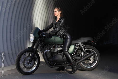 woma in black with a motorcycle