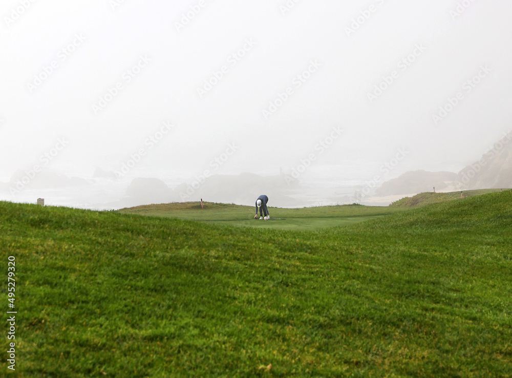golfer on foggy golf course golfer on foggy golf course