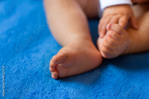 Baby legs on the bed