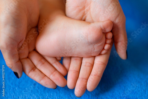 The woman tenderly embraced the baby's legs