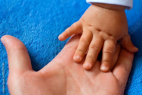 Children's hand on the palm of a woman