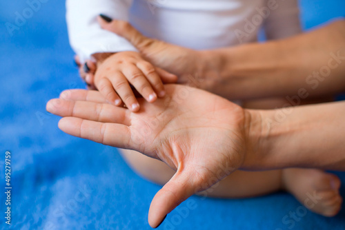 Children's hand on the palm of a woman