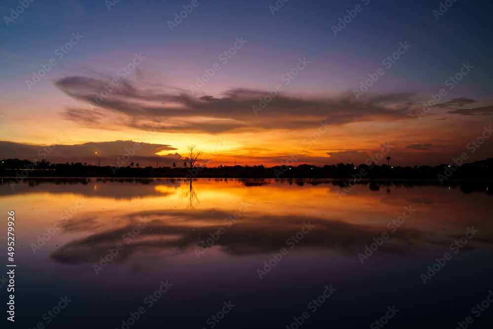 Colorful sunset at the swamp. Nature landscape. Reflection sky, cloud and sunlight.