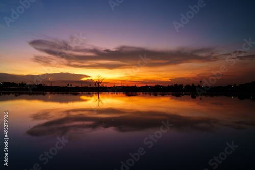 Colorful sunset at the swamp. Nature landscape. Reflection sky, cloud and sunlight. © Mind plus