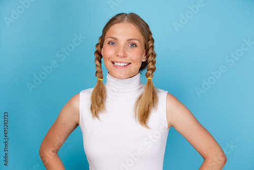 Konstfotografi Close up portrait of young attractive smiling girl with pigtails standing isolat