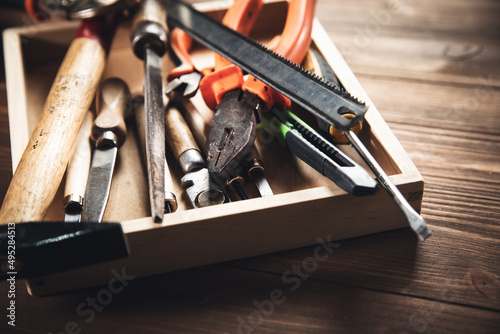 different construction tools on wooden background photo